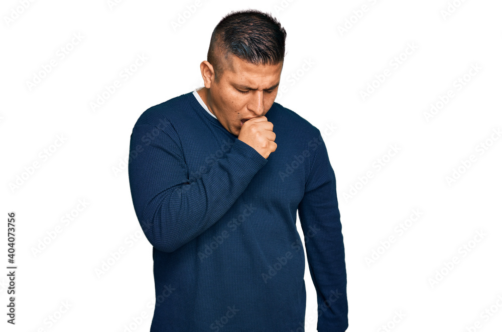 Young latin man wearing casual clothes feeling unwell and coughing as symptom for cold or bronchitis. health care concept. Young latin man wearing casual clothes feeling unwell and coughing as symptom for cold or bronchitis. health care concept.