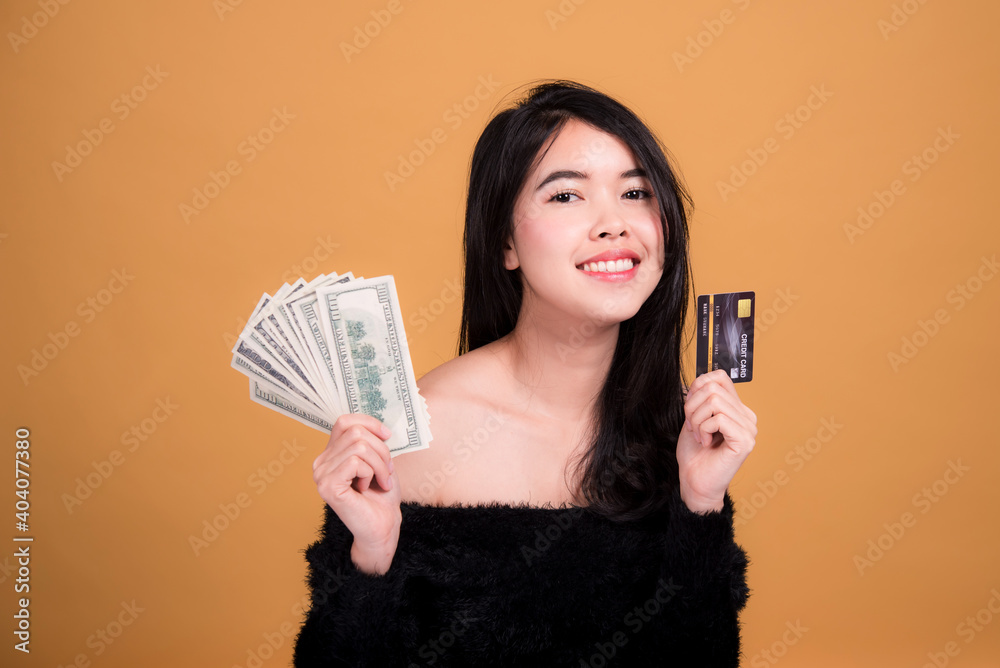 Young smiling Asian woman presenting credit card in hand showing trust and confidence for making payment,Reliable financial company Young smiling Asian woman presenting credit card in hand showing trust and confidence for making payment,Reliable financial company