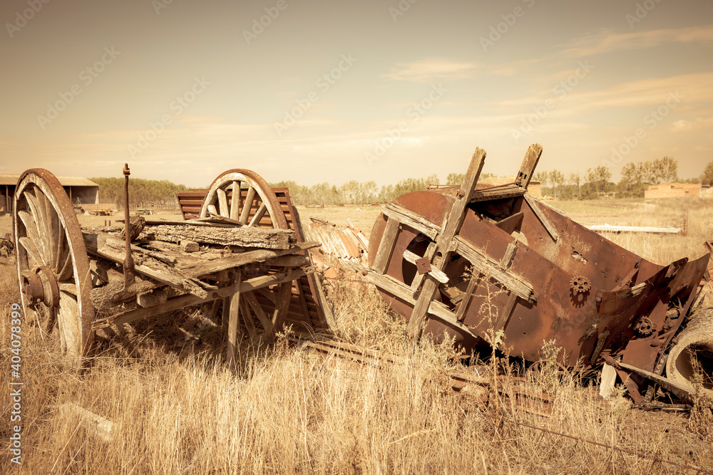 Fototapeta premium old rusty vintage Farm Equipment - old chariot and an old hay baler