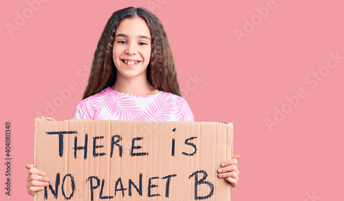 Cute hispanic child girl holding there is no planet b banner looking positive and happy standing and smiling with a confident smile showing teeth © Krakenimages.com