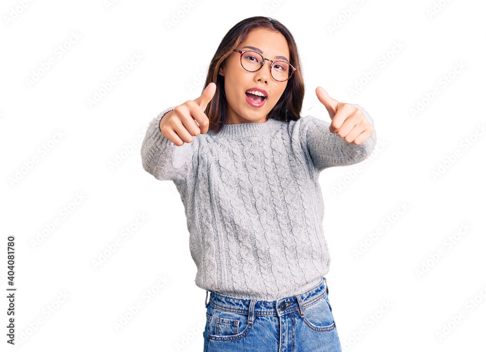 Young beautiful chinese girl wearing casual clothes approving doing positive gesture with hand, thumbs up smiling and happy for success. winner gesture. Young beautiful chinese girl wearing casual clothes approving doing positive gesture with hand, thumbs up smiling and happy for success. winner gesture.
