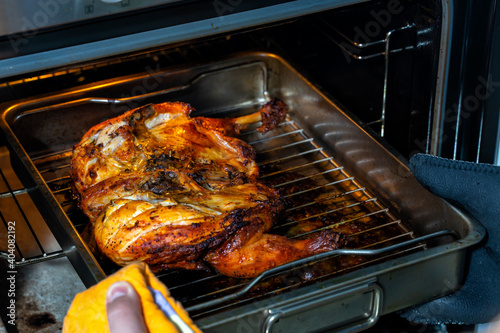 the cooked chicken is taken out of the oven close-up