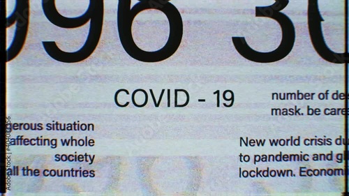 COVID-19 sign in the middle. Dynamic blinking Global outbreak information reports, world news, titles, keywords. Noise, vhs, glitch effects. International media concept. Coronavirus. 4K animation 