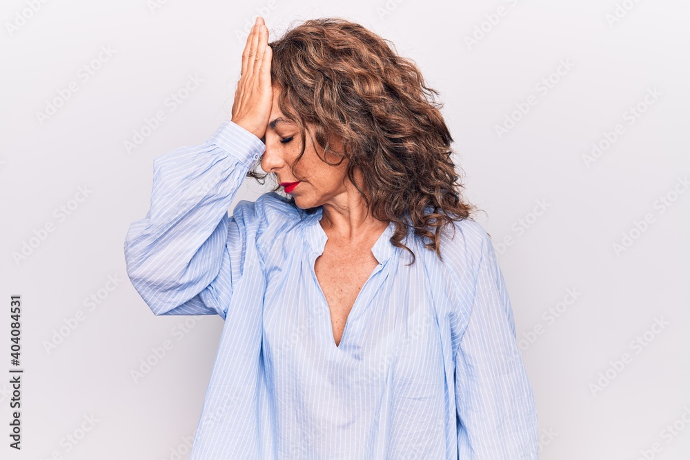 Middle age beautiful brunette woman wearing striped shirt standing over white background surprised with hand on head for mistake, remember error. Forgot, bad memory concept. Middle age beautiful brunette woman wearing striped shirt standing over white background surprised with hand on head for mistake, remember error. Forgot, bad memory concept.