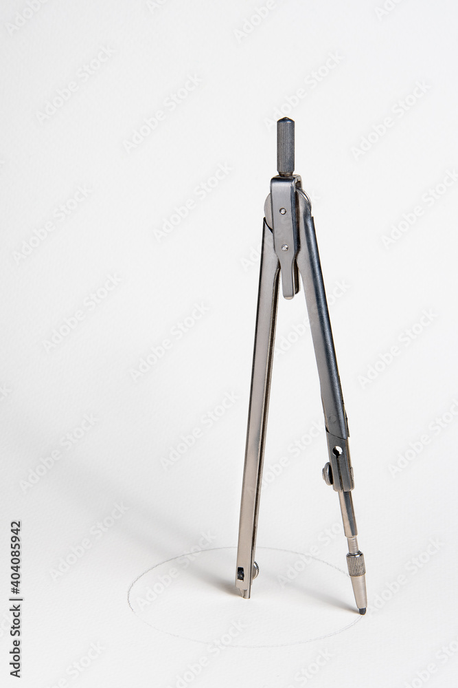 Compass draws a circle on a white Whatman paper Compass draws a circle on a white Whatman paper