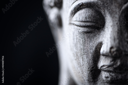 Meditating Buddha Statue isolated on black background. Copy space.	