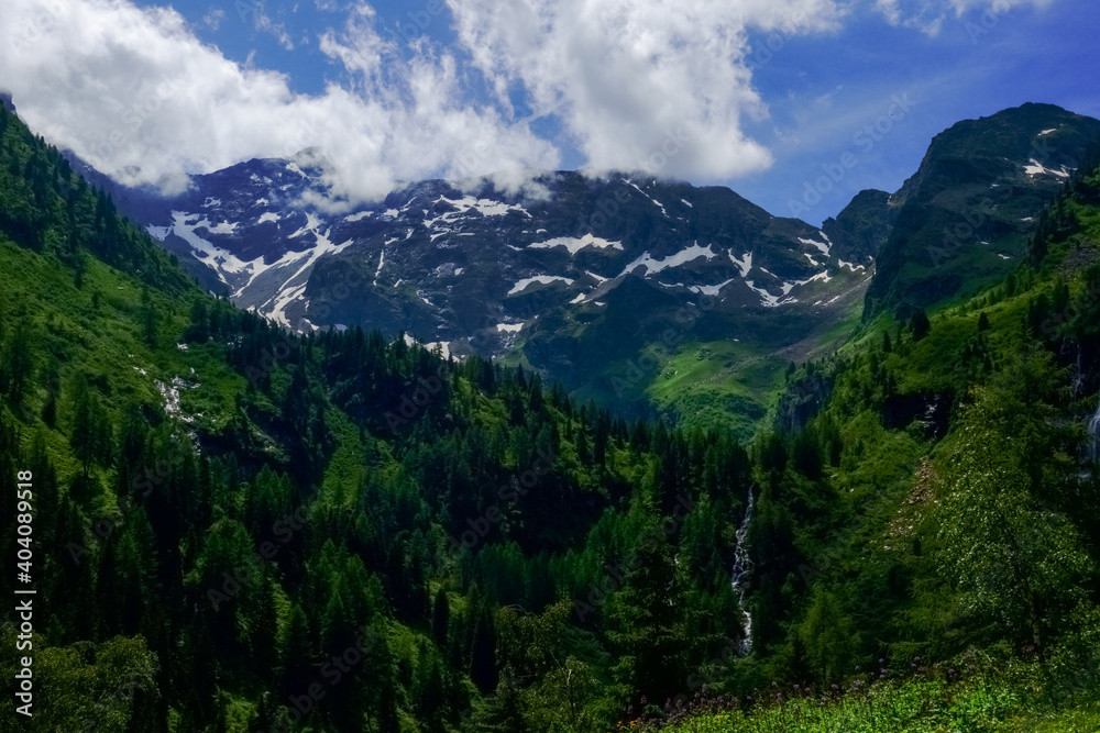 beautiful mountains with snow in a green landscape