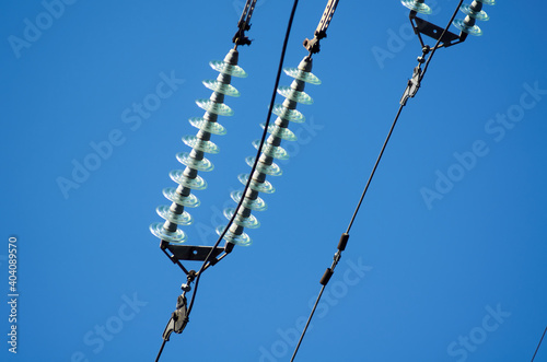 Electric line with insulators against blue sky