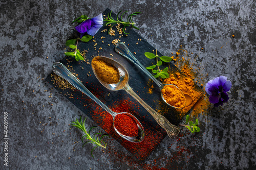 A black board with colourful spices arranged for cooking. Copy Space. photo