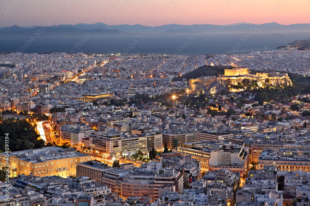 View of the city of Athens, during sunset. On the right there can be seen Acropolis and the Parthenon, and on bottom left the Greek Parliament.