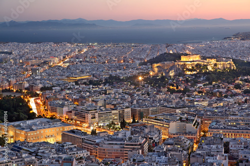 View of the city of Athens  during sunset. On the right there can be seen Acropolis and the Parthenon  and on bottom left the Greek Parliament.
