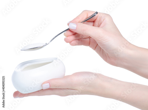 Sugar bowl with teaspoon in hand on white background isolation