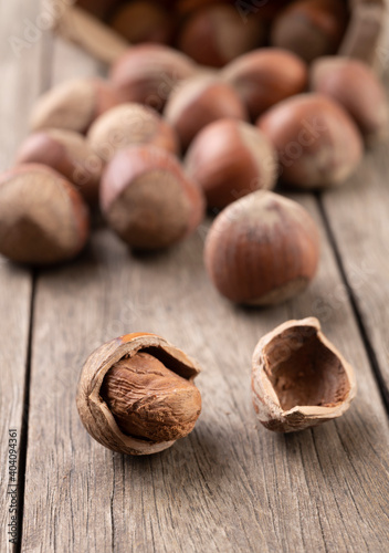 A group of hazelnuts in narrow focus over wooden table