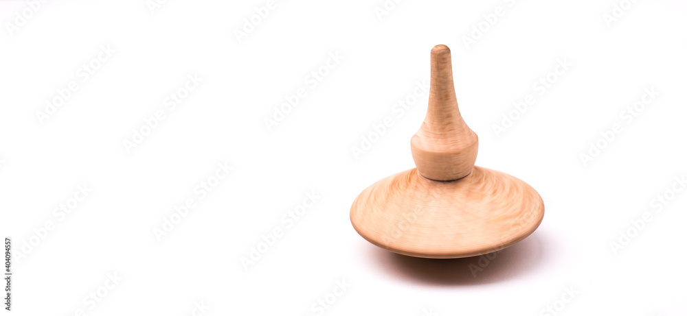 Close up shot of a wooden spinning top moving Close up shot of a wooden spinning top moving