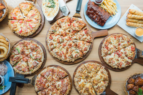 A lot of pizza in plates, Top view fast food.