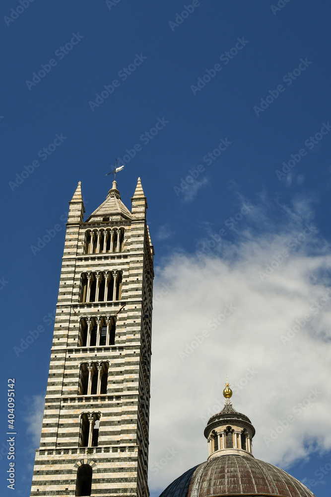 Bell tower and dome of the Siena Cathedral in Romanesque style, with white and green marble bands, it was completed in 1313 and reaches a height of 77 meters, Siena, Tuscany, Italy