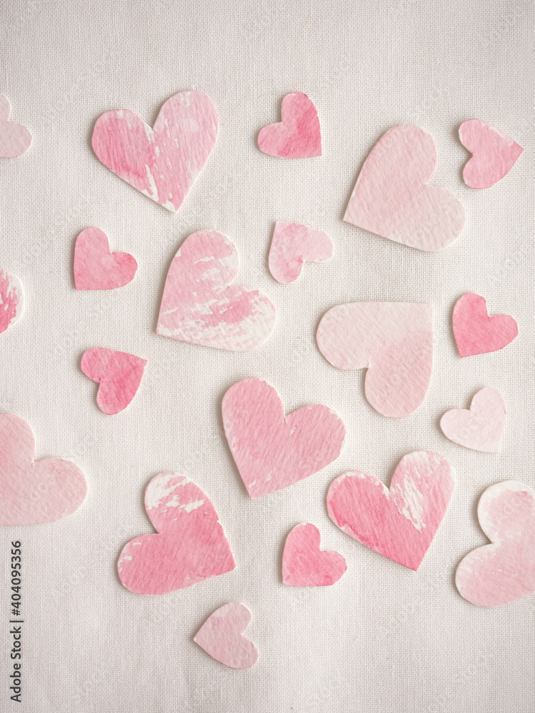 Fototapeta premium Paper hearts painted in pink watercolor on a white background
