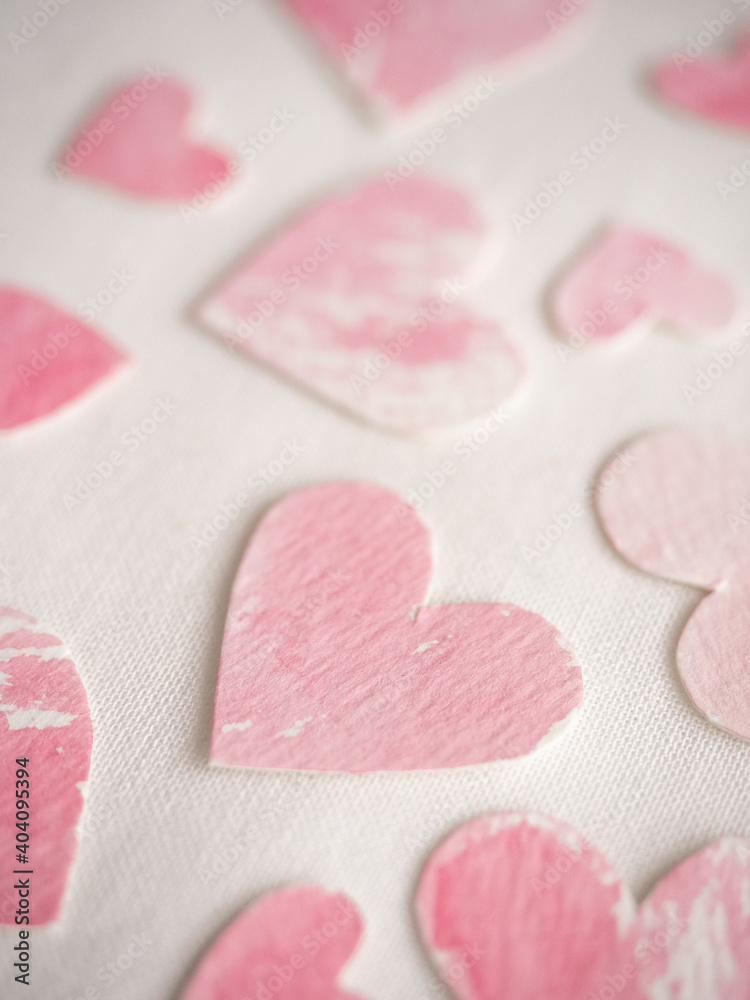 Fototapeta premium Paper hearts painted in pink watercolor on a white background