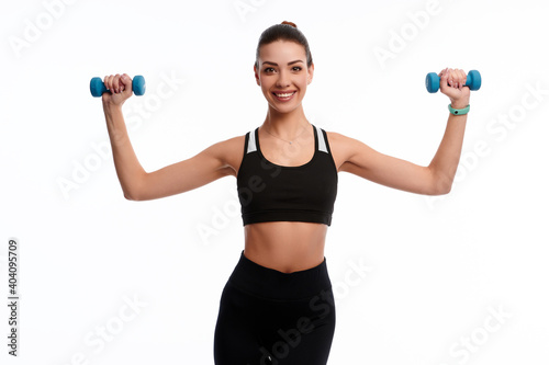 Attractive caucasian slim woman doing physical exercise using dumbbell isolated on white background
