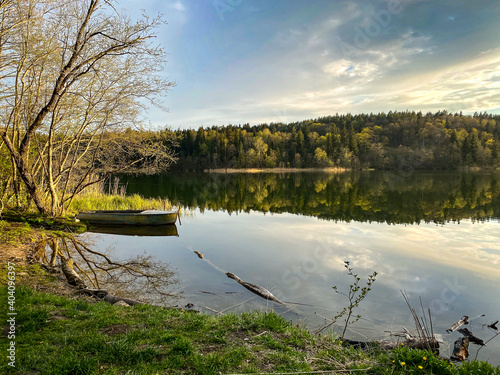 Lake Balsys panorama with small boat in the evening by drone photo