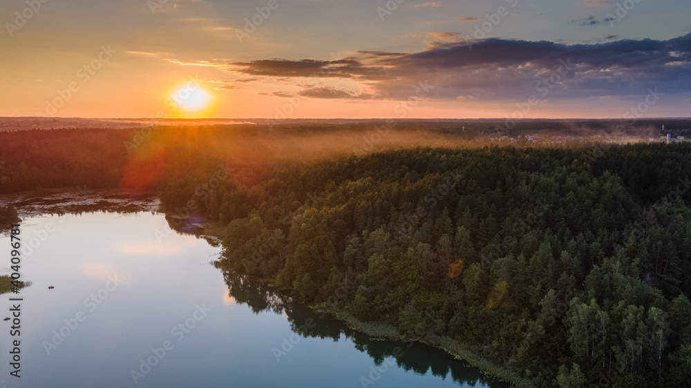 Aerial view of beautiful sunset near lake in Lithuania by drone