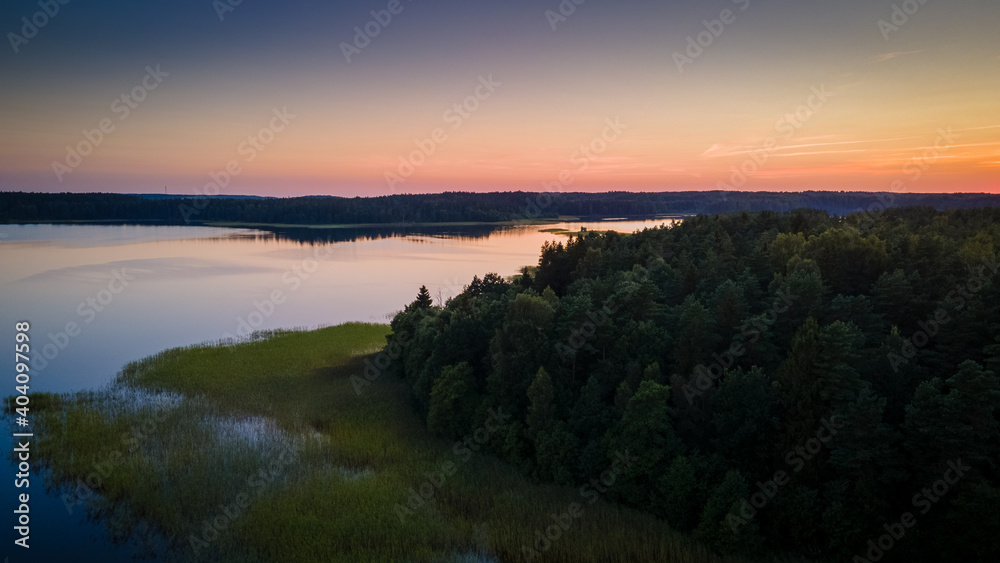 Aerial view of lake Plateliai panorama during sunset by drone