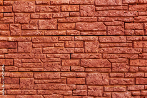 Background texture red, stone brick wall. Surface with a brickwork of bricks of different sizes