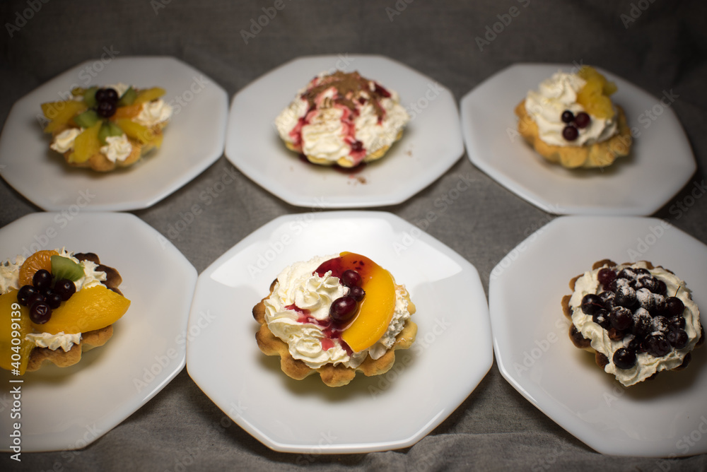 tartlets made of dough with cream and fruit tartlets made of dough with cream and fruit