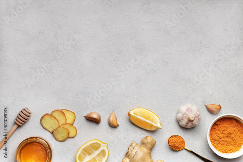 Set of products for making beverages on white background. Ingridient for drinks to support immune system and prevent diseases turmeric, honey, ginger and lemon. Herbal medicine. Copy space, flat lay