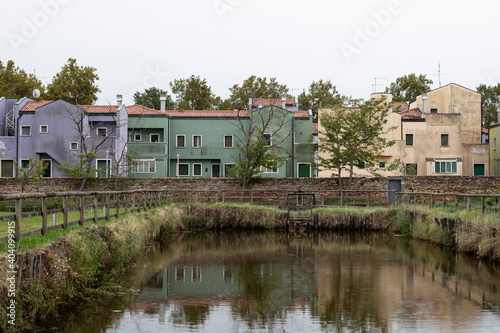 Colorful houses in front of a lagoon lake in Mazzorbo, Venice, Italy