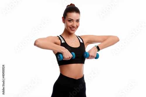 Attractive caucasian slim woman doing physical exercise using dumbbell isolated on white background