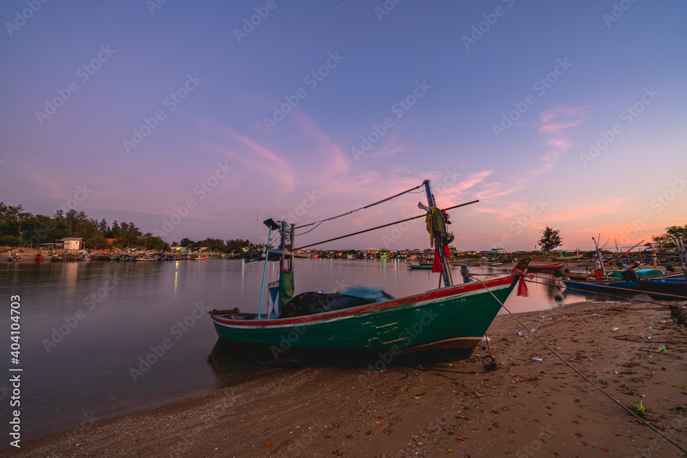 Beautiful twilight sunset sky at pier and estuary with lot of fisherman ships Beautiful twilight sunset sky at pier and estuary with lot of fisherman ships