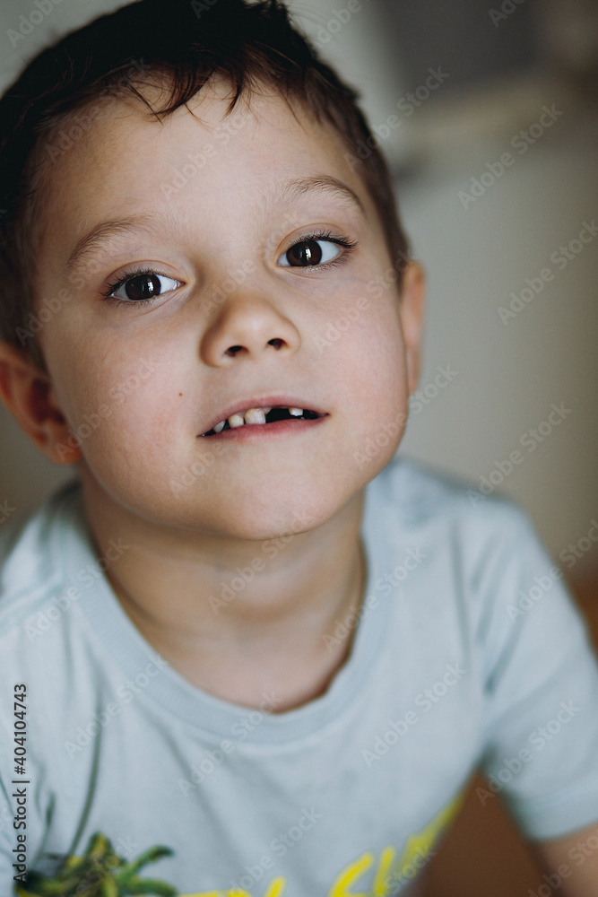 close up portrait of cute caucasian 6 year old boy with lost front tooth