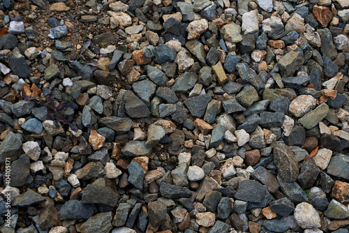 Granite paving stones. Wet cobblestones. Old path. Close up view. Texture.