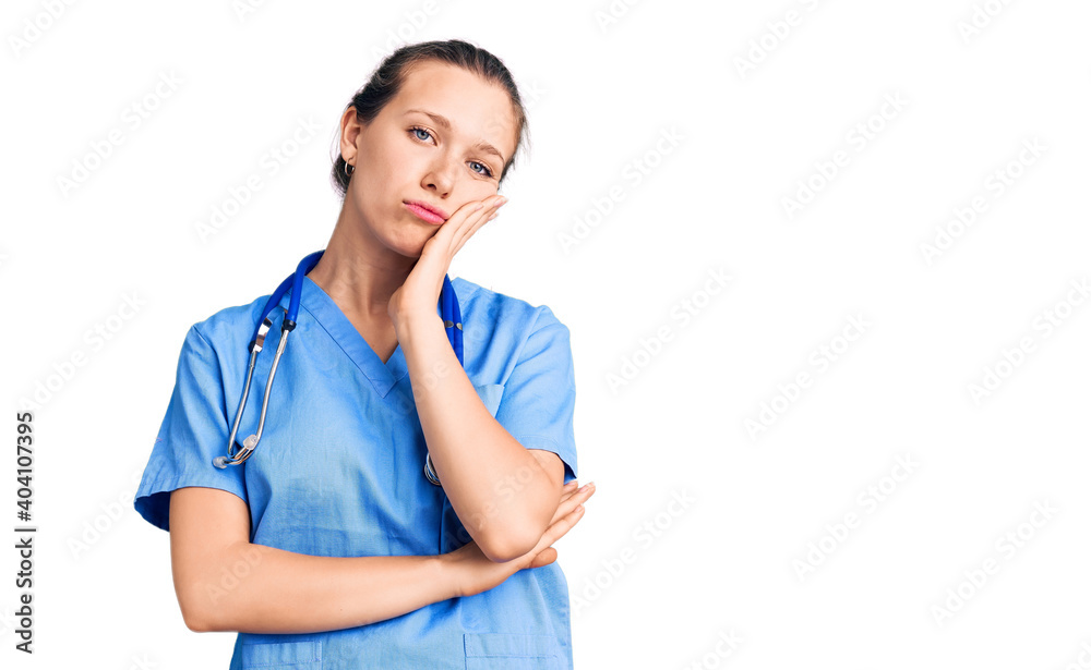 Young beautiful blonde woman wearing doctor uniform and stethoscope thinking looking tired and bored with depression problems with crossed arms. Young beautiful blonde woman wearing doctor uniform and stethoscope thinking looking tired and bored with depression problems with crossed arms.