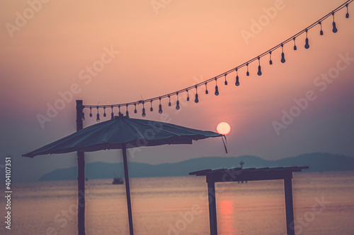 sunset on the beach with beach umbrella  © pushish images