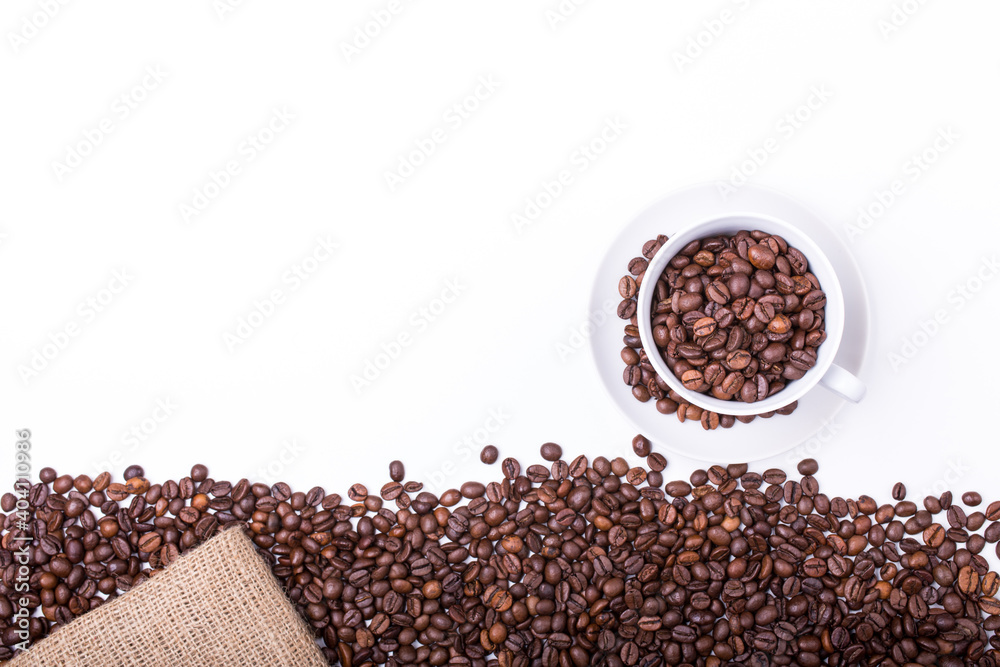 Naklejka premium top view of White cup filled with freshly roasted coffee beans