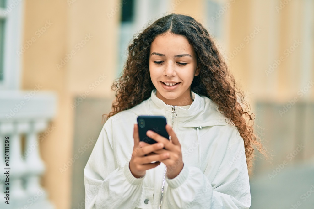 Beautiful hispanic girl smiling happy using smartphone at the city. Beautiful hispanic girl smiling happy using smartphone at the city.