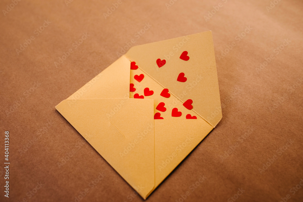 Yellow open envelope full of lots of red hearts.
