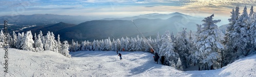 Panoramic mountain view of beautiful mountain peaks at snow day on the top of Stowe Mountain Ski resort, Vermont - December 2020 photo