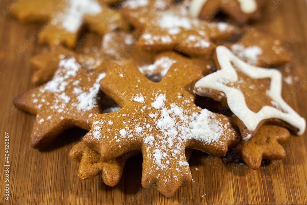 Ginger biscuits with sugar powder on a wooden board. Ginger biscuits with sugar powder on a wooden board.