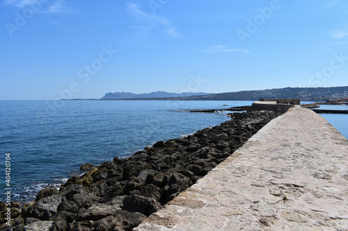 stone beach next to the pier photo