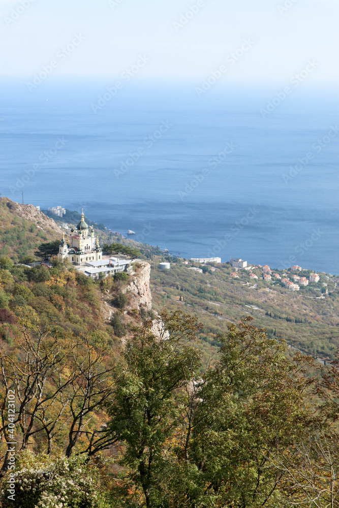 Scenic autumn view from the top of the mountain Baydar gate to the Foros church and coastline of Black sea in Crimea