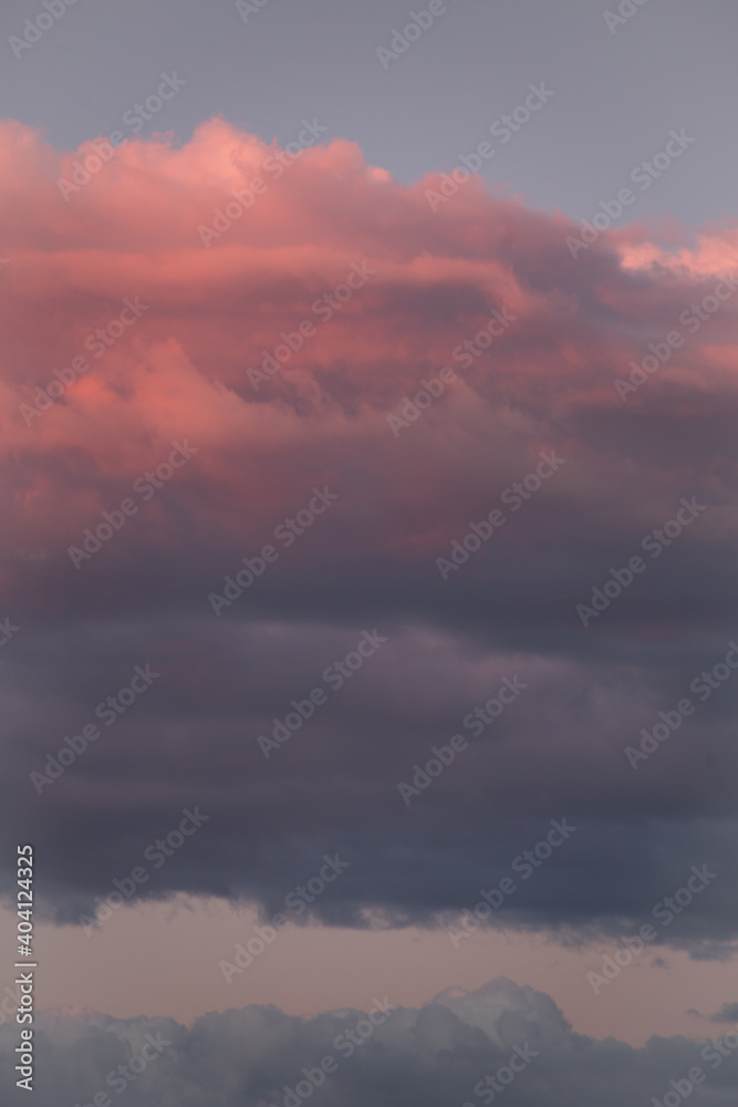 Natural color dramatic dawn or dusk sky with painterly yellow, pink and blue clouds with horizon, taken with normal 50 mm lens for sky replacement