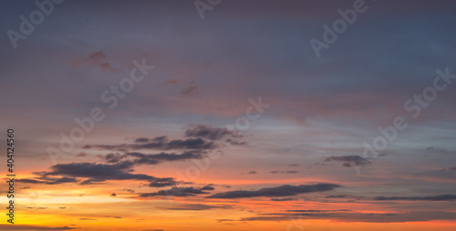Natural color dramatic dawn or dusk sky with painterly yellow, pink and blue clouds with horizon, taken with wide angle 35 mm lens for sky replacement