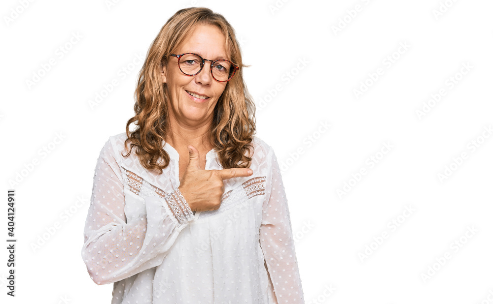Middle age blonde woman wearing casual white shirt and glasses cheerful with a smile of face pointing with hand and finger up to the side with happy and natural expression on face Middle age blonde woman wearing casual white shirt and glasses cheerful with a smile of face pointing with hand and finger up to the side with happy and natural expression on face