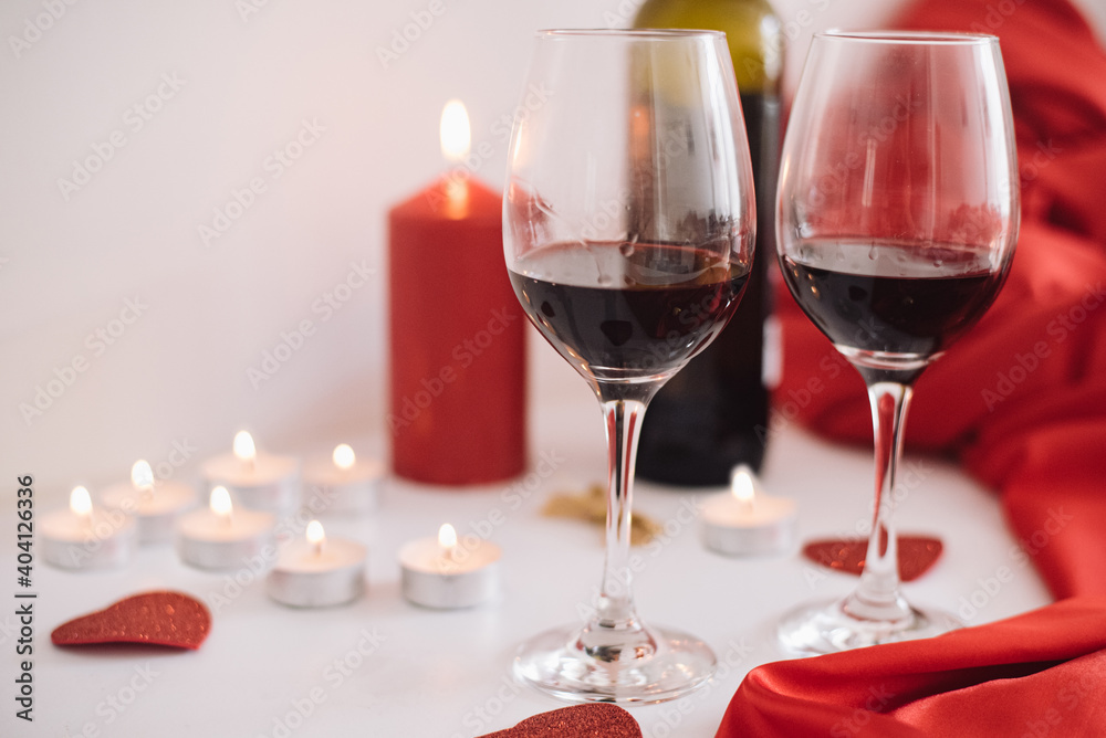 Two glasses of red wine and candles create a romantic, unforgettable evening for lovers. In Lovely Valentine day in 14th February get a surprise. Gifts, surprises, declarations of love Two glasses of red wine and candles create a romantic, unforgettable evening for lovers. In Lovely Valentine day in 14th February get a surprise. Gifts, surprises, declarations of love