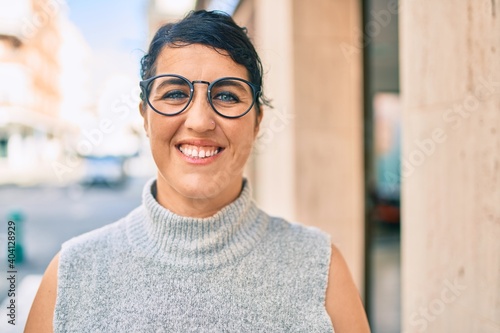 Young plus size woman smiling happy walking at the city. © Krakenimages.com