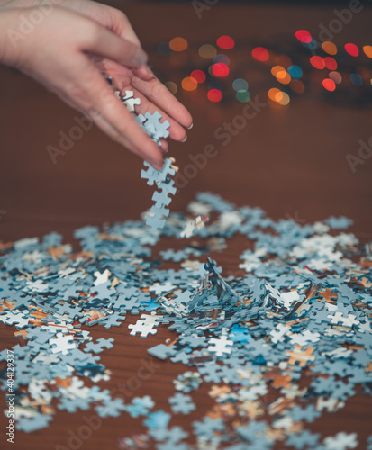 close up of hands holding puzzle