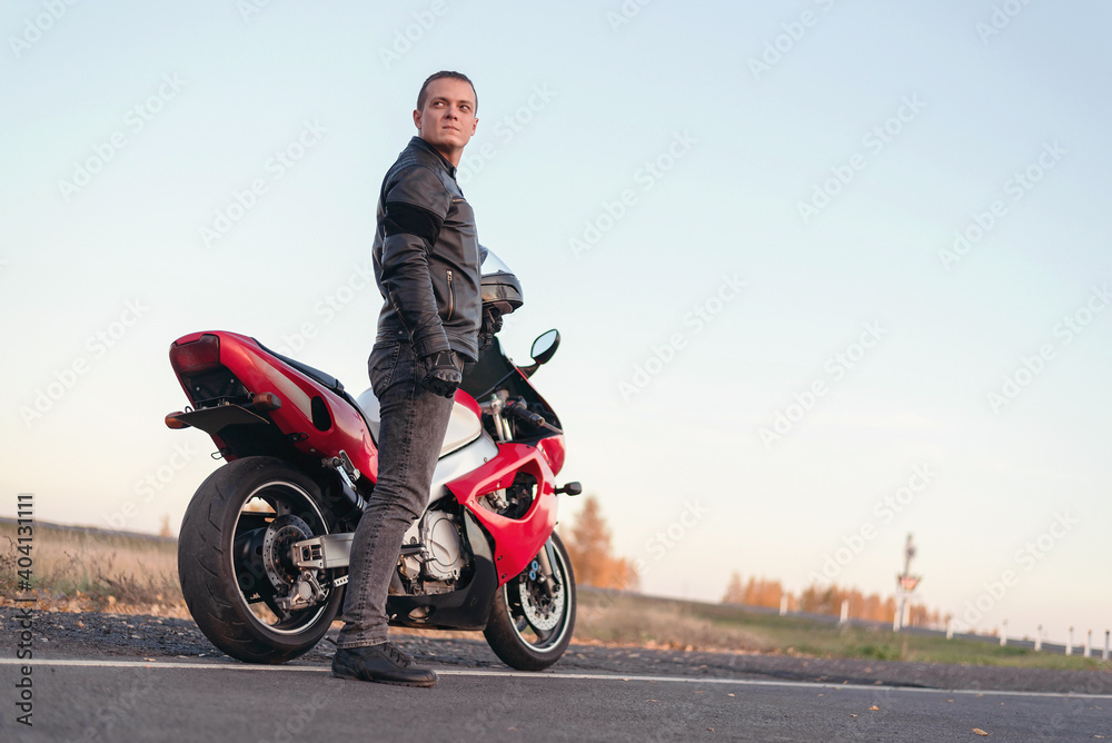 Obraz premium Motor biker is standing on the road.